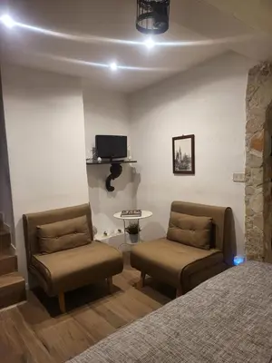 a bedroom with two chairs and a bed and a table at Il Rifugio in Palermo