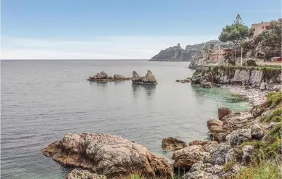 a large body of water with rocks in it at Casa Sardina in Mandra Capreria