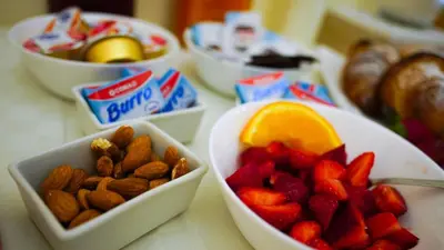 a table topped with bowls of fruit and nuts at LE PORTE DI PALERMO in Palermo