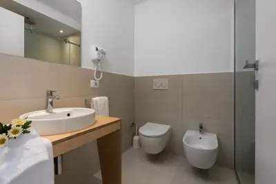 a bathroom with a sink and a toilet at Vitop Residence in San Vito lo Capo