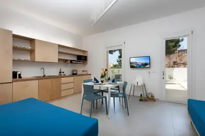 a kitchen and dining room with a table and chairs at Vitop Residence in San Vito lo Capo