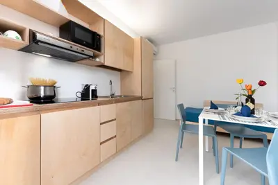 a kitchen and dining room with a table and chairs at Vitop Residence in San Vito lo Capo