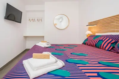 a bedroom with a bed with towels on it at B&B Lo&G in Lascari