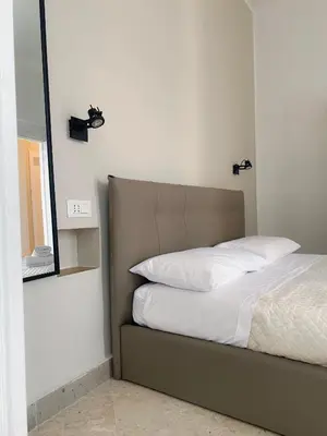 a bedroom with a bed and a mirror at Leone Suite B&B & Restaurant AIC in Palermo