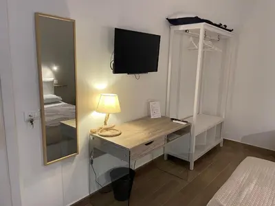 a room with a desk with a mirror and a bed at Leone Suite B&B & Restaurant AIC in Palermo
