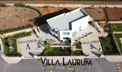 an aerial view of a white house with a building at Villa Laurum - Giardino degli allori - Castellammare del Golfo - Scopello in Castellammare del Golfo