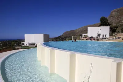 a pool of water with buildings in the background at Villa Laurum - Giardino degli allori - Castellammare del Golfo - Scopello in Castellammare del Golfo