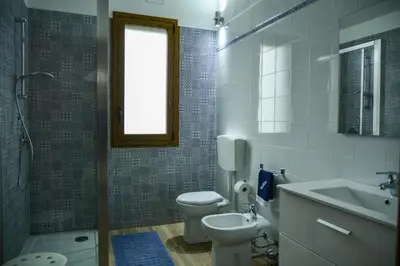a bathroom with a toilet and a sink and a shower at Casa Pomelia in Castellammare del Golfo