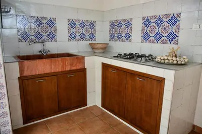 a kitchen with a sink and a counter top at Casa Pomelia in Castellammare del Golfo