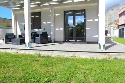 a house with a patio with chairs on it at Suite Capaci in Capaci