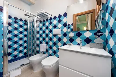 a bathroom with a toilet and a sink and a shower at Azulè in San Vito lo Capo