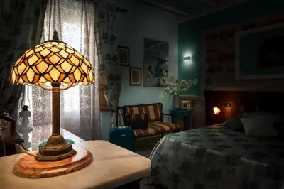 a lamp sitting on a table in a bedroom at Azulè in San Vito lo Capo