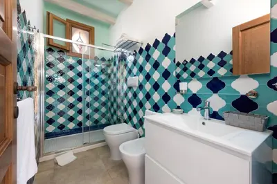 a bathroom with a toilet and a sink at Azulè in San Vito lo Capo