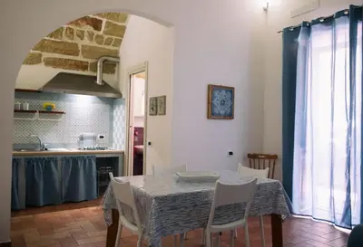 a kitchen and dining room with a table and chairs at La casetta in Terrasini