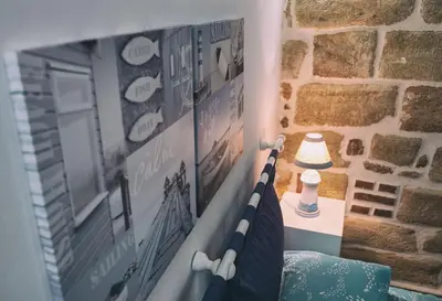a bedroom with a bed with a tv and a wall at La casetta in Terrasini