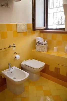 a bathroom with a toilet and a sink at Mau House 44 Apartment in Palermo
