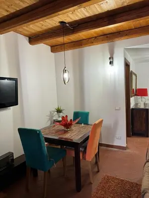 a dining room with a wooden table and chairs at Mau House 44 Apartment in Palermo