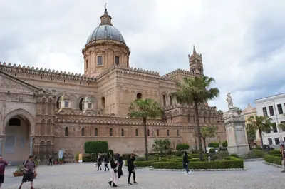 a group of people walking in front of a building at CATHEDRAL APARTMENT in Palermo