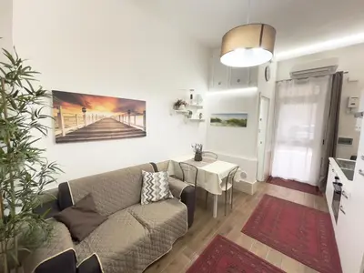 a living room with a couch and a table at CATHEDRAL APARTMENT in Palermo
