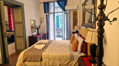a bedroom with a bed and a large window at Casa Rdue a quiet historic center of Palermo in Palermo