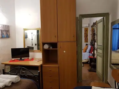 a room with a desk with a computer and a mirror at Casa Rdue a quiet historic center of Palermo in Palermo