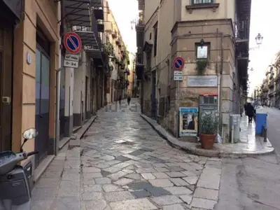 an empty street in a city with buildings at Casa Rdue a quiet historic center of Palermo in Palermo