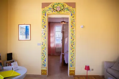 a hallway with a mirror in a room at Solemar Sicilia - Casa Enza in Santa Flavia