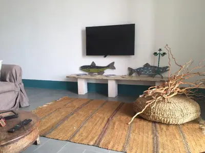 a living room with a table with a flat screen tv at Casa Nonnona in Palermo