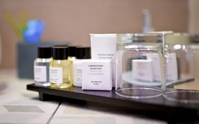 a shelf with several bottles of cosmetics on it at Delle Vittorie Luxury Rooms&Suites in Palermo
