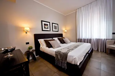 a bedroom with a large bed and a window at Delle Vittorie Luxury Rooms&Suites in Palermo
