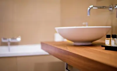 a white sink on a wooden counter in a bathroom at Delle Vittorie Luxury Rooms&Suites in Palermo