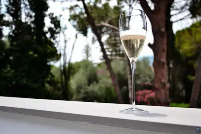 a glass of white wine sitting on a ledge at B&b Mondello Resort in Palermo