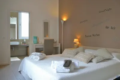 a bedroom with a white bed with towels on it at B&b Mondello Resort in Palermo