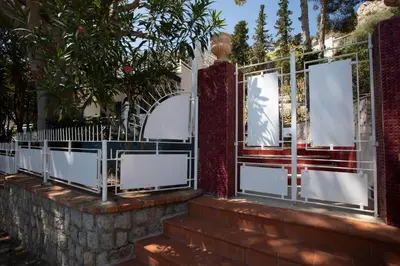 a white gate with a stone wall at Villa Aurora Mondello Addaura in Mondello
