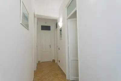 a hallway with white walls and a white door at Villa Aurora Mondello Addaura in Mondello
