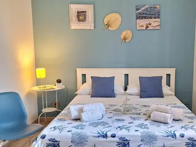 a bedroom with a bed with a blue wall at Sea Room Aspra in Bagheria