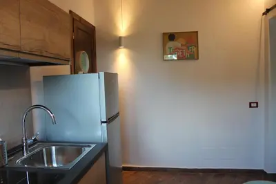 a kitchen with a white refrigerator and a sink at Mondello Apartment in Mondello