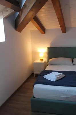 a bedroom with a bed and a lamp on a table at Mondello Apartment in Mondello