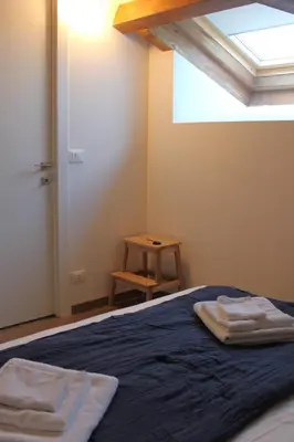 a bedroom with a bed with two towels on it at Mondello Apartment in Mondello
