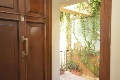 a door with a painting of a balcony at Krimar Hotel in San Vito lo Capo