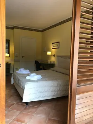 a bedroom with a bed with towels on it at Krimar Hotel in San Vito lo Capo