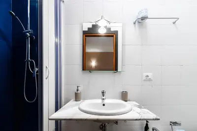 a bathroom with a sink and a mirror at Hotel City Center in Palermo