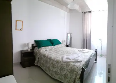 a white bedroom with a bed and a window at Duchessa in Castellammare del Golfo