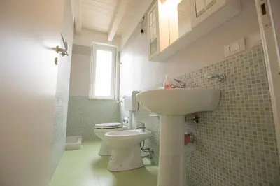 a bathroom with a sink and a toilet at Duchessa in Castellammare del Golfo