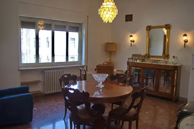 a dining room with a table and a mirror at Olivarooms in Palermo