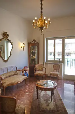 a living room filled with furniture and a chandelier at Olivarooms in Palermo