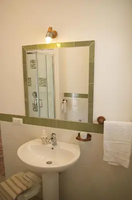a bathroom with a sink and a mirror at Olivarooms in Palermo