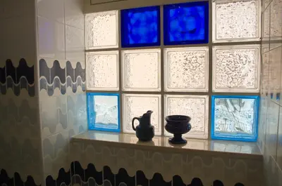a table with a vase on it in front of a window at Olivarooms in Palermo