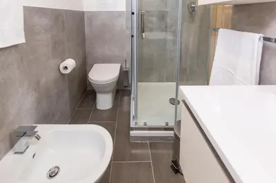 a bathroom with a toilet and a sink and a shower at Mosina Apartments in Palermo