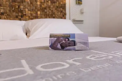 a book sitting on top of a bed at Mosina Apartments in Palermo